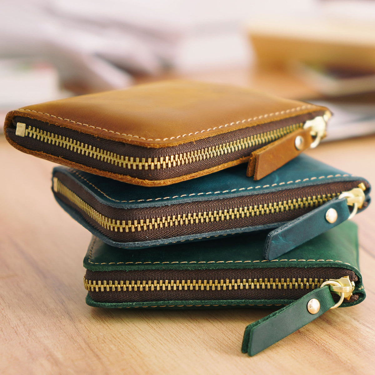 Stack of colourful leather zip wallets and card holders for everyday use
