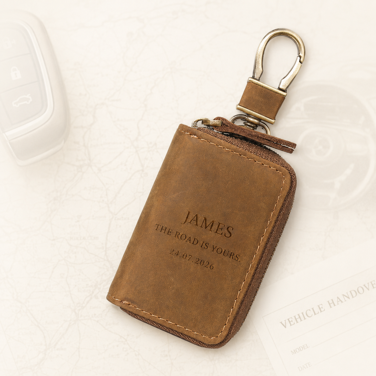 Brown personalised leather key pouch with engraved message and metal clip