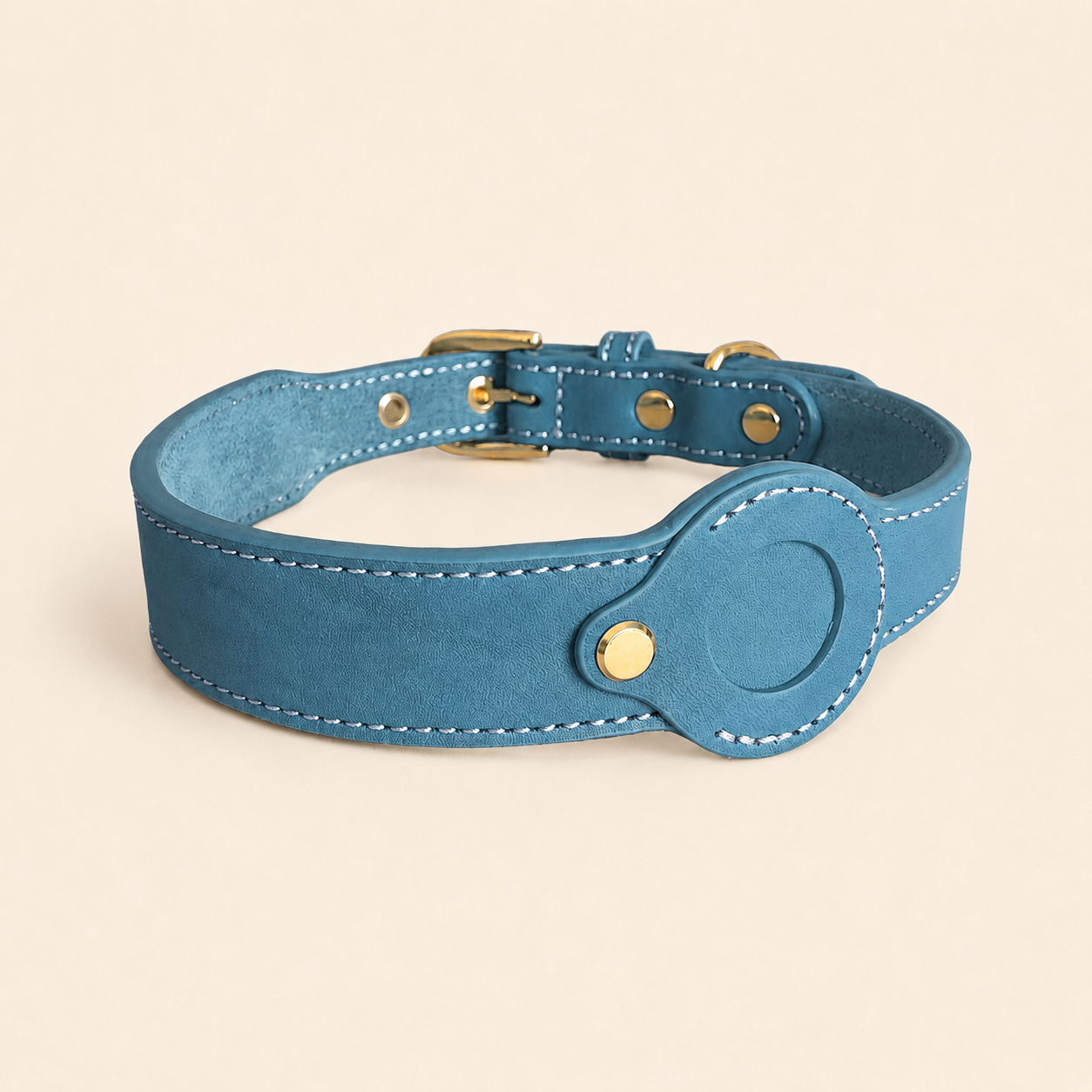 blue dog collar showing the removable leather AirTag holder without an AirTag installed