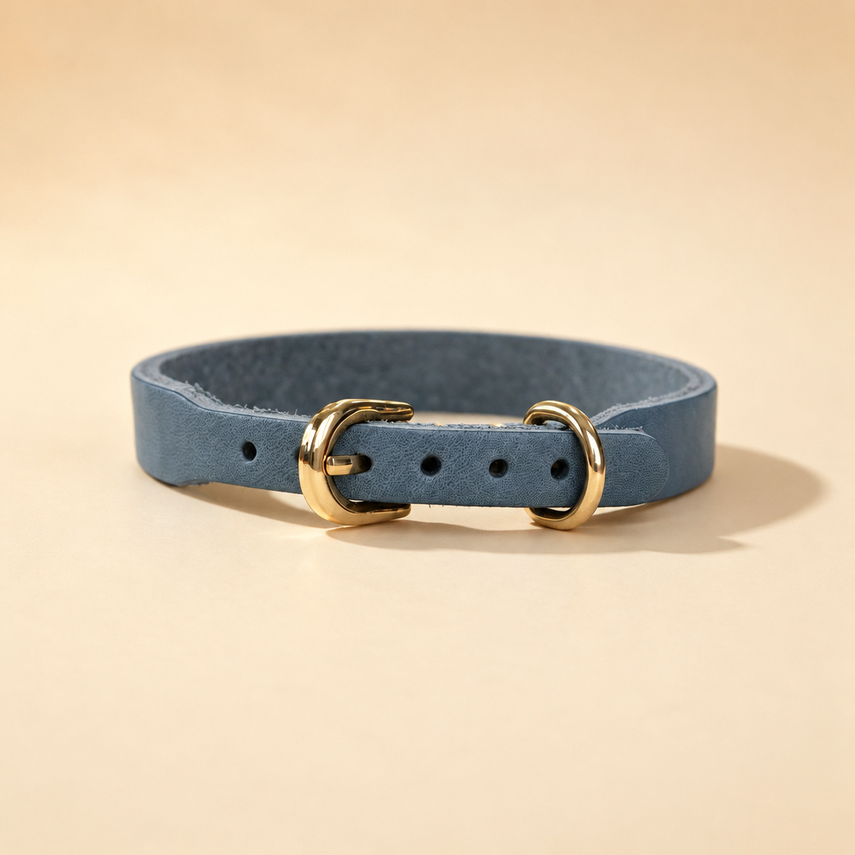 Blue full-grain leather dog collar with adjustable buckle holes and pale-gold D-ring
