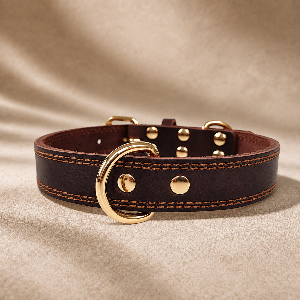 Chocolate full-grain leather dog collar with dual D-rings, brown stitching and polished gold-tone hardware.