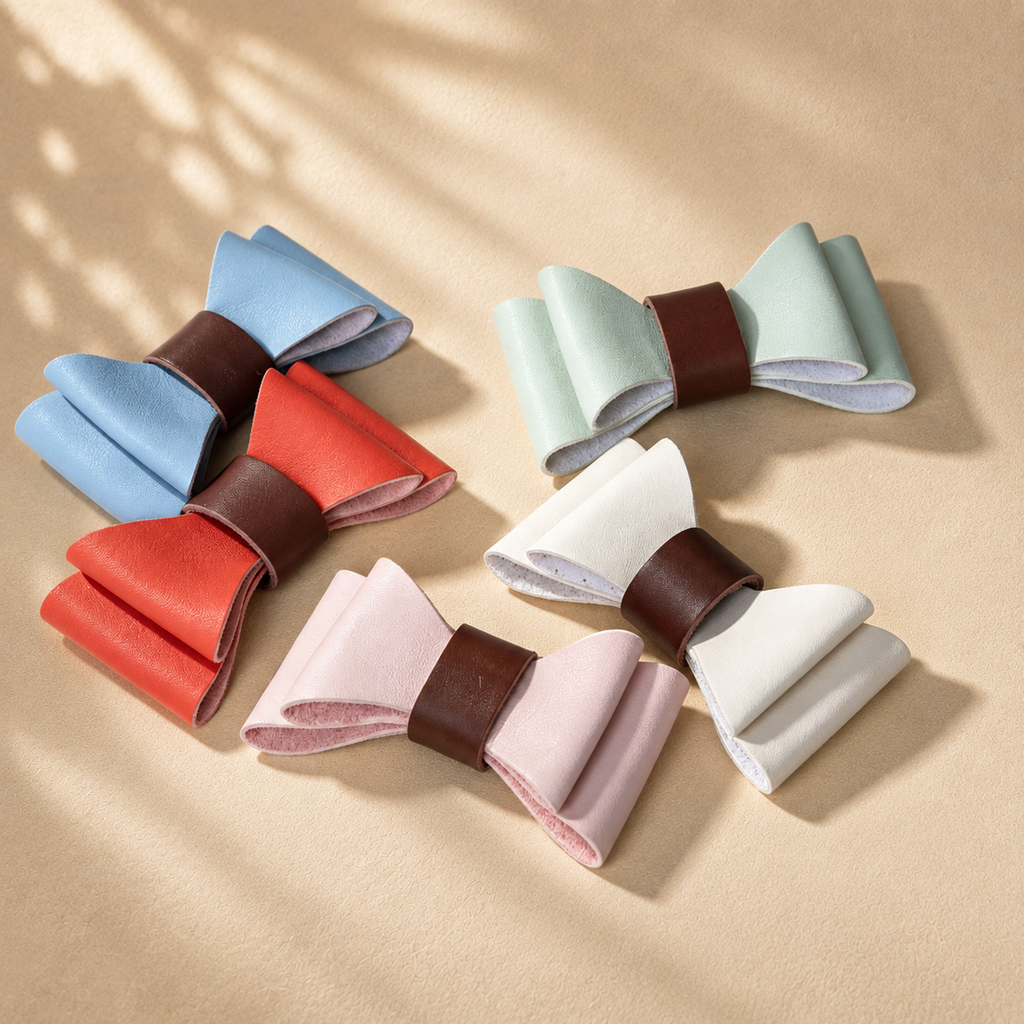 Five detachable microfibre dog bow ties in light blue, red, mint green, white and pale pink with brown centre bands.