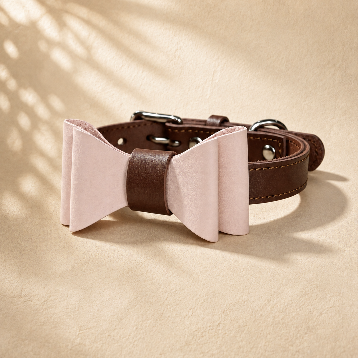 Brown full-grain leather dog collar with a detachable pale pink microfibre bow tie.