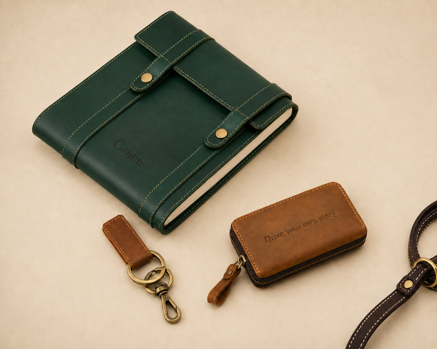 Personalised leather journal, key pouch, keyring and leash arranged together