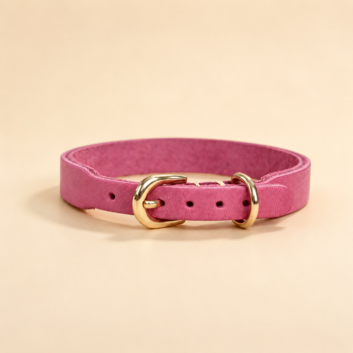 Pink full-grain leather dog collar with adjustable buckle holes and pale-gold D-ring