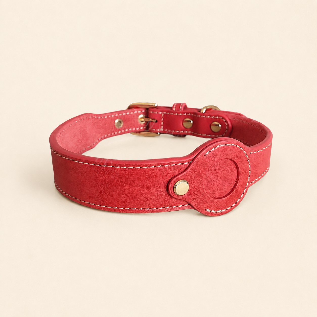 Red dog collar showing the removable leather AirTag holder without an AirTag installed