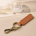 Tan Crazy Horse leather double-ring keyring with antique brass-tone swivel clip